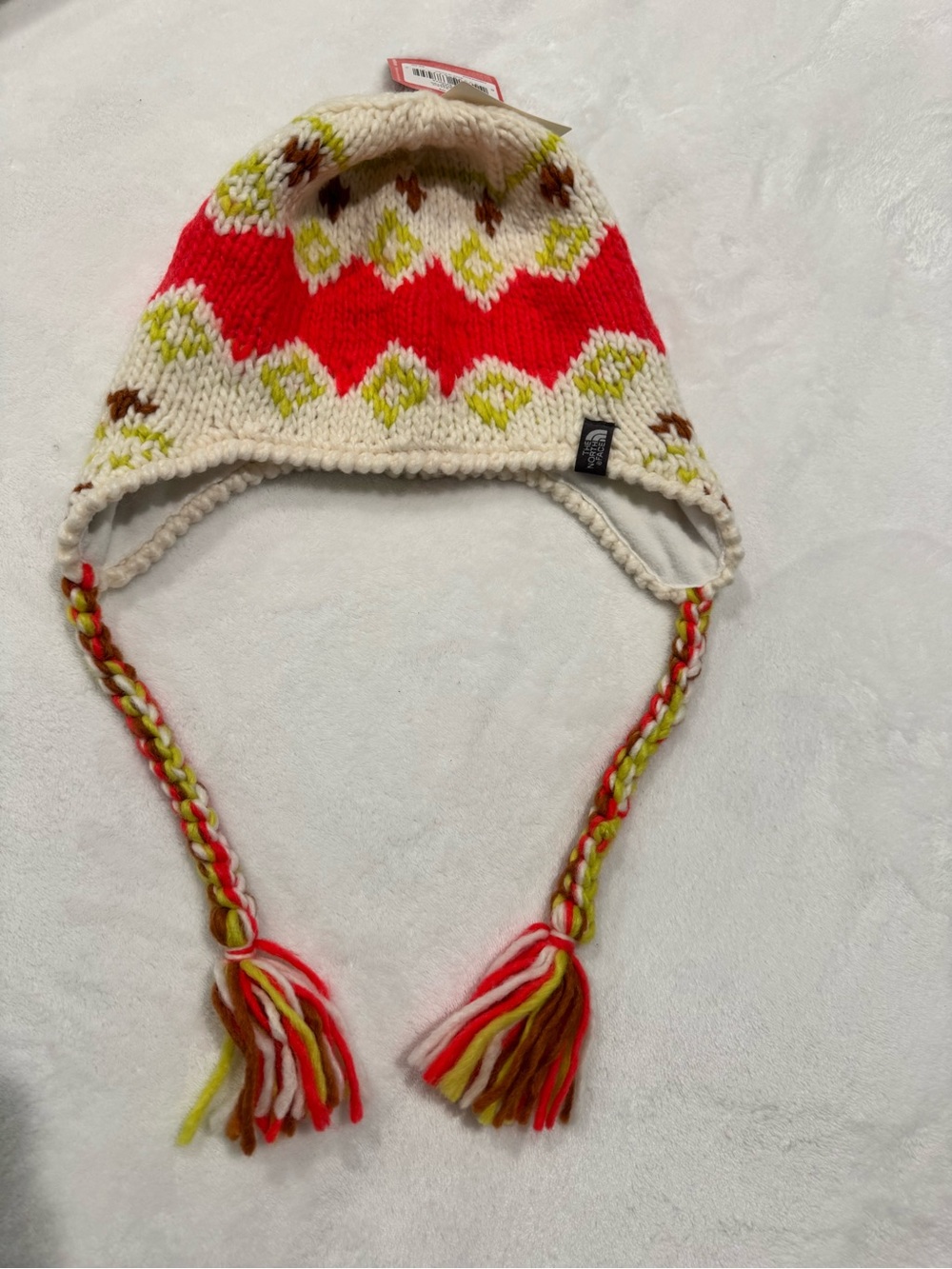 The North Face Vagabond hand knit earflap beanie with tassels.  OS